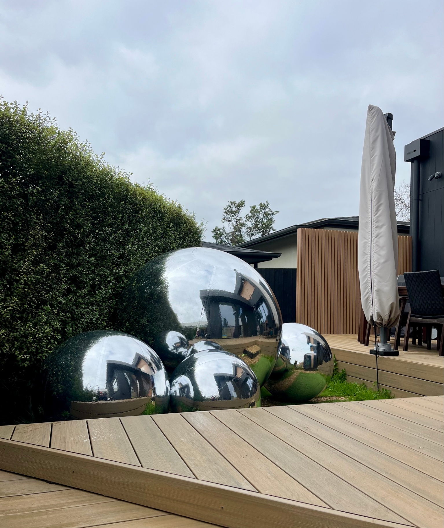 Mirror spheres styled on a backyard deck